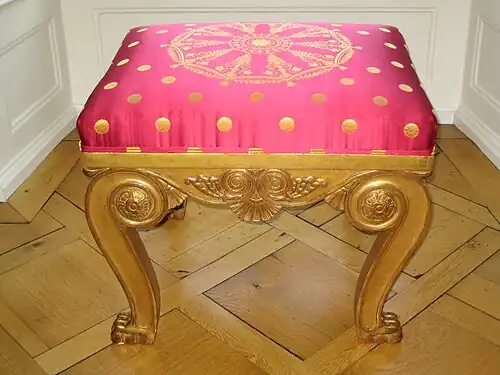 Neoclassical rosettes on a stool, by François-Honoré-Georges Jacob-Desmalter, c.1810, gilded wood, unknown location