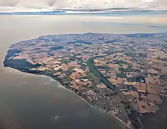 Aerial view of Strøby Egede (lower right) through Køge Sønakke (leftmost tip), looking southeast across Køge Bay