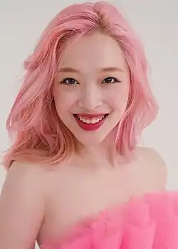 A still image of Choi smiling toward the camera