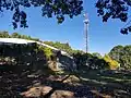 Concrete water tank and radio antenna at summit