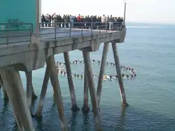 A surfer memorial service being held at the Huntington Beach Pier