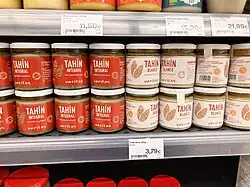 Unhulled tahini (left) and hulled "white" tahini (right) on a store shelf in Barcelona