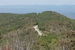 Road turning on top of a forested ridge