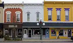 A photo of taxpayer buildings in Boston, with streetcar tracks in the foreground.