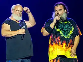 Two men with microphones on stage