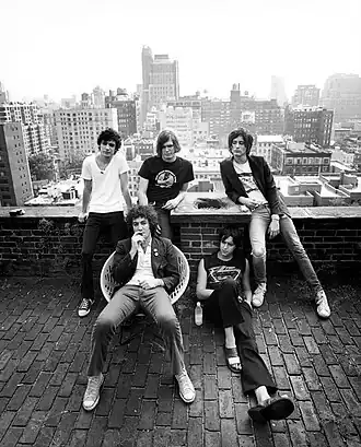 The Strokes on the Chelsea Hotel rooftop in 2003; clockwise from top-left: Fabrizio Moretti, Nikolai Fraiture, Nick Valensi, Julian Casablancas, and Albert Hammond Jr.