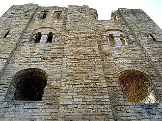 Limestone ashlar masonry in even courses at Scarborough Castle. The buttresses of low profile are characteristic of Romanesque building.