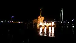 Keeper of the Plains in December, 2010 at night. View from the banks of the Arkansas River, with the "Ring of Fire" aflame.