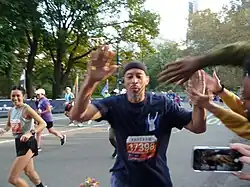 Thomas high-fiving friends while running