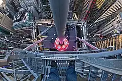 The Times Square Ball, a multicolored ball, as seen from the roof of One Times Square in 2012. Traffic at street level is visible in the background.