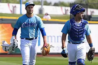 Men in light blue baseball uniforms with white pants