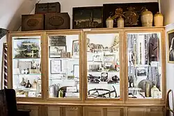 Display cabinet at the Burford Tolsey Museum with items of Burford's trades and crafts