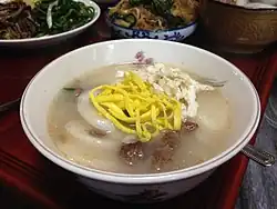 Tteokguk topped with egg garnish strips