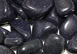 Tumble-polished blue goldstone pieces.