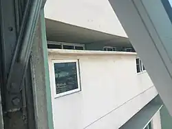 20&nbsp;in (510&nbsp;mm) separation between corridors showing apartment windows.