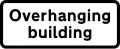 Supplementary plate informing height limit warning is of an overhanging building