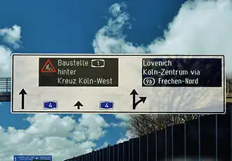 A row matrix LED sign on an interchange of a German Autobahn with side graphics display.