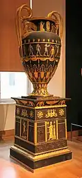 Egyptian Revival vase with pedestal; 1804–1806; varnished sheet and gilded bronze; height: 1.80 m, depth: 0.95 m; Louvre[17]