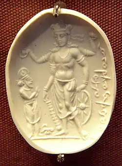 Vishnu Nicolo Seal representing Vishnu with a worshipper (probably Mihirakula), 4th–6th century CE. The inscription in cursive Bactrian reads: "Mihira, Vishnu and Shiva". British Museum.