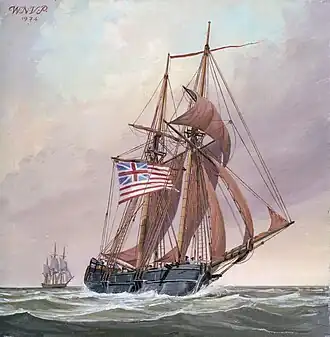 A two-masted wooden sailing ship is shown in full sail on the sea. It is flying the flag of the United Colonies: thirteen red and white stripes, with a British Union Jack in the upper left quadrant. Another ship is visible in the distance.