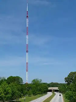 An antenna tower 1,075 feet (328&nbsp;m) tall in Atlanta, GA with its red and white aircraft warning paint visible.