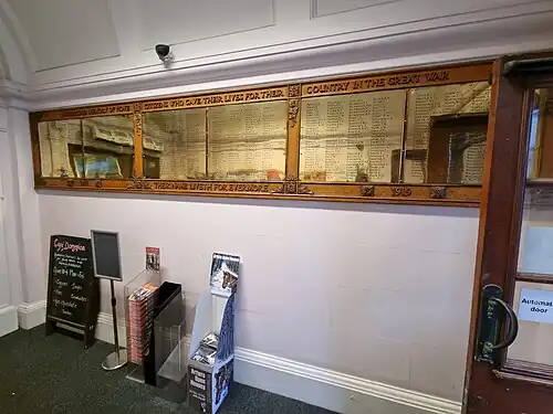 Bronze plaques with names embossed, fixed to a wall