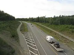 View of a highway surrounded by forest.