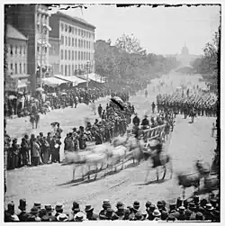 Infantry unit with fixed bayonets followed by ambulances passing on Pennsylvania near the Treasury