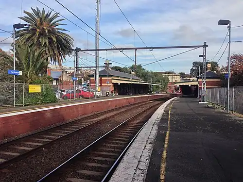 West Richmond station Platform 2 looking south, showing the two station buildings on each platform