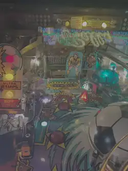 The soccer goal and its keeper at the top of the playfield with the spinning soccer ball to its right and the free kick zone to its left.