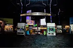 Museum interior, with displays in a large space and World Video Game Hall of Fame on a hanging sign.