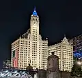 Night view of the Wrigley Building, from a boat on the Chicago River, with the northeast corner of the DuSable Bridge