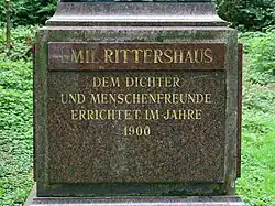 The statue's plaque, it reads "To the poet and philanthropist, established in 1900"