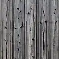 Charred yakisugi wood cladding on an older building façade in Kyoto, with vertical grain orientation