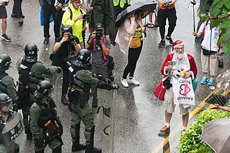 A non-Chinese protester dressed as Santa Claus was asked by riot police to return to the pavement.