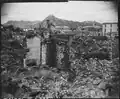 Scene of war damage in residential section of Seoul. The capitol building can be seen in the background (right). 18 October 1950.