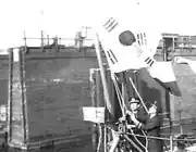 Korean naval officers raising a flag on the ship Pak Tu San at the Brooklyn Navy Yard, 1949