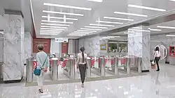 De verdeelhal met, boven de roltrappen, een eerbetoon aan de volksmilitie