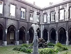 Laatgotische kloostergangen en pandhof met beeld van Notger