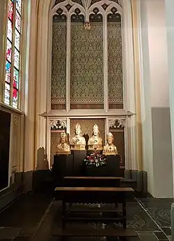 Dezelfde wand in 2022 met reliekbustes van bisschoppen