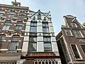 Woonhuis/winkel in traditioneel bouwen met eclectische invloeden en art-nouveau-detaillering