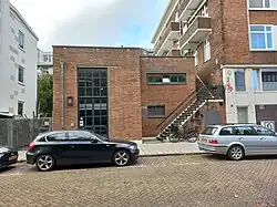 Ingang Populierenweg 87-90, met links nog gespikkelde flat (oktober 2022)