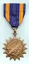 Air Medal 30 november 1953 - Luitenant bij de RAAF No. 77 Squadron.[5]