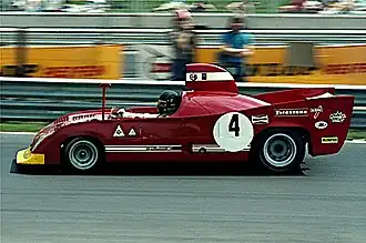 Andrea de Adamich op de Nürburgring rijdend in een Alfa Romeo Tipo 33 TT 12 (1974)