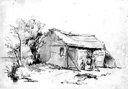 Drie kinderen voor boerenhut aan waterkant