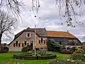 Boerderij met goed bouwlichaam, dat door verscheidene uitbreidingen een onregelmatige vorm verkregen heeft