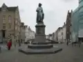 Het standbeeld van Jan van Eyck, met op de achtergrond de Spiegelrei (en gelijknamige waterloop) en Spinolarei.