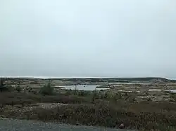 Kaal en met meertjes bezaaid landschap gezien vanaf de TCH