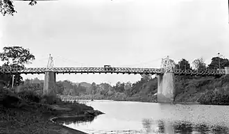 Een auto rijdt op een brug over de rivier Walanae in Watansoppeng, Zuid-Sulawesi (1923-1925).