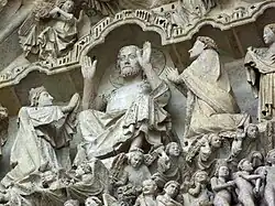 Het timpaan van het Laatste Oordeel : de Christus van het Oordeel. Aan zijn zijde, geknield, Maria en Johannes de Doper als voorspraak voor het heil der zielen